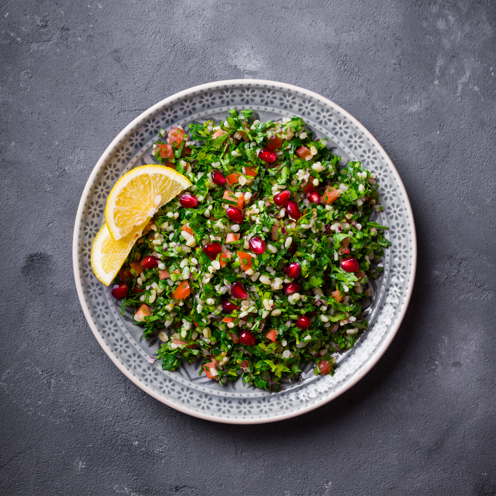 Grain salad with pomegranate and lemon slices 